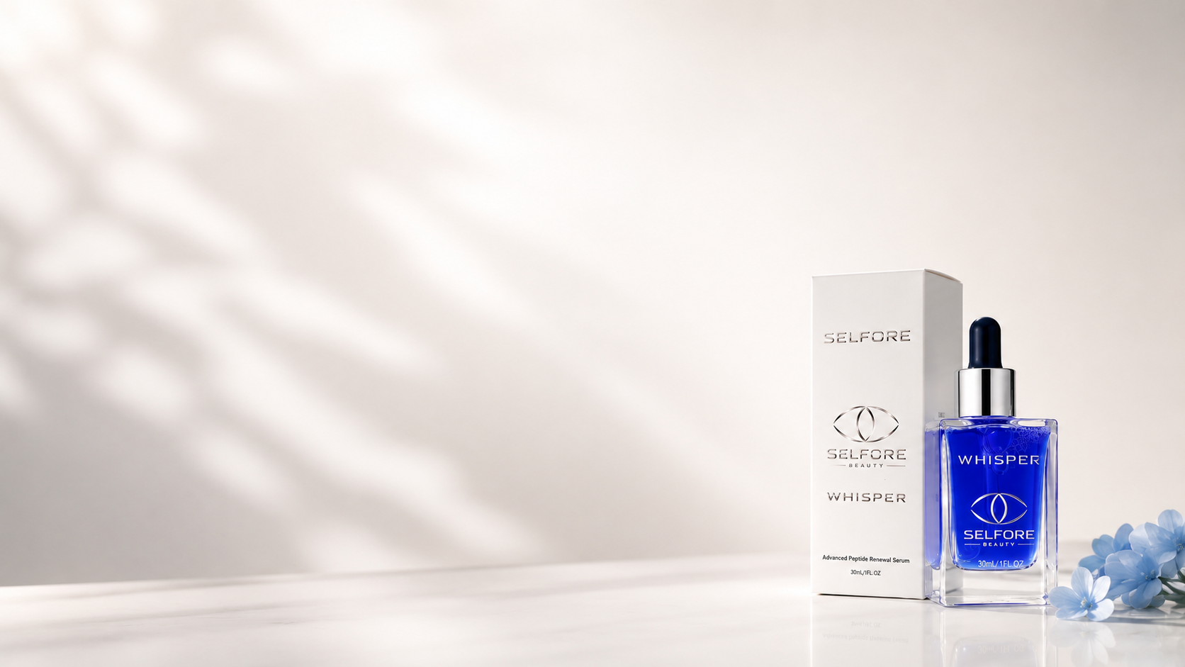 Selfore Whisper Advanced Peptide Renewal Serum - a cobalt-blue 30ml glass dropper bottle beside its silver-embossed white Selfore Whisper carton, with pale blue blossoms on a sunlit marble surface.